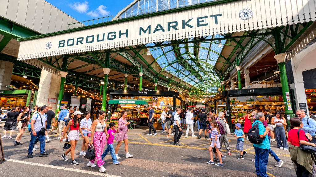 Borough Market in London, featuring its historic entrance, colourful food stalls and visitors exploring the bustling market.