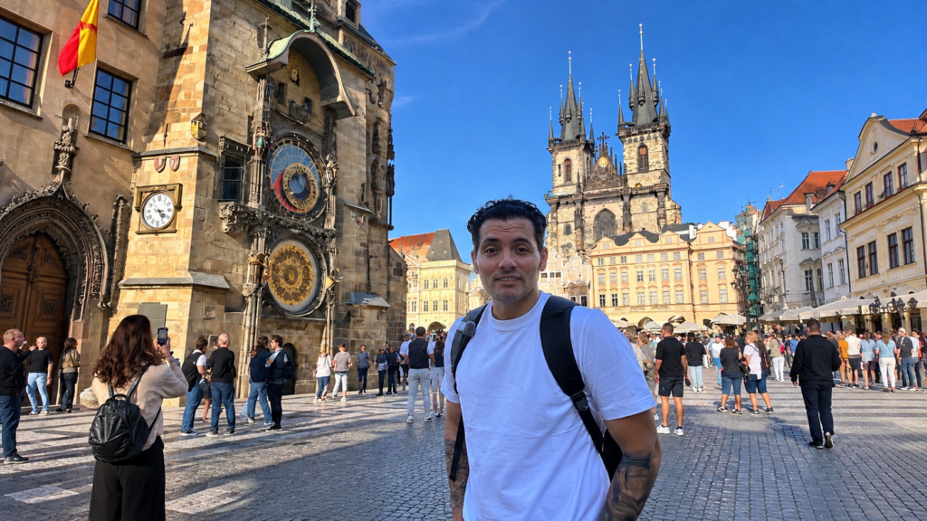 Arash in Prague's Old Town Square, with the Astronomical Clock and Church of Our Lady before Týn in the background