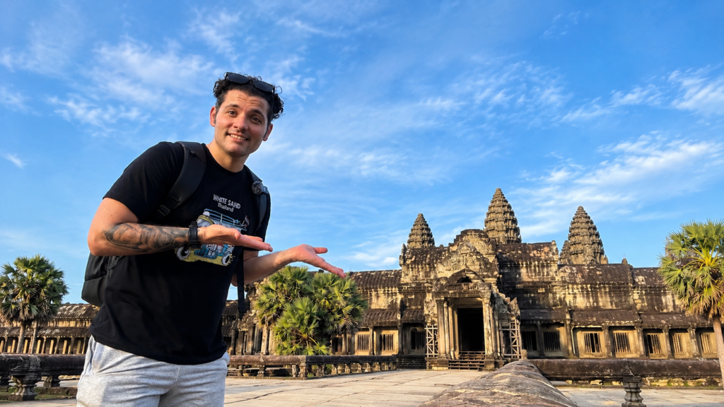Exploring Angkor Wat in Siem Reap, Cambodia, with the ancient temple and its iconic towers in the background.